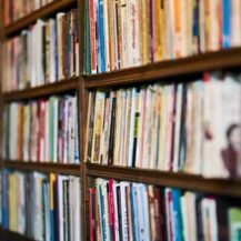 assorted-books-on-wooden-shelf-2943603